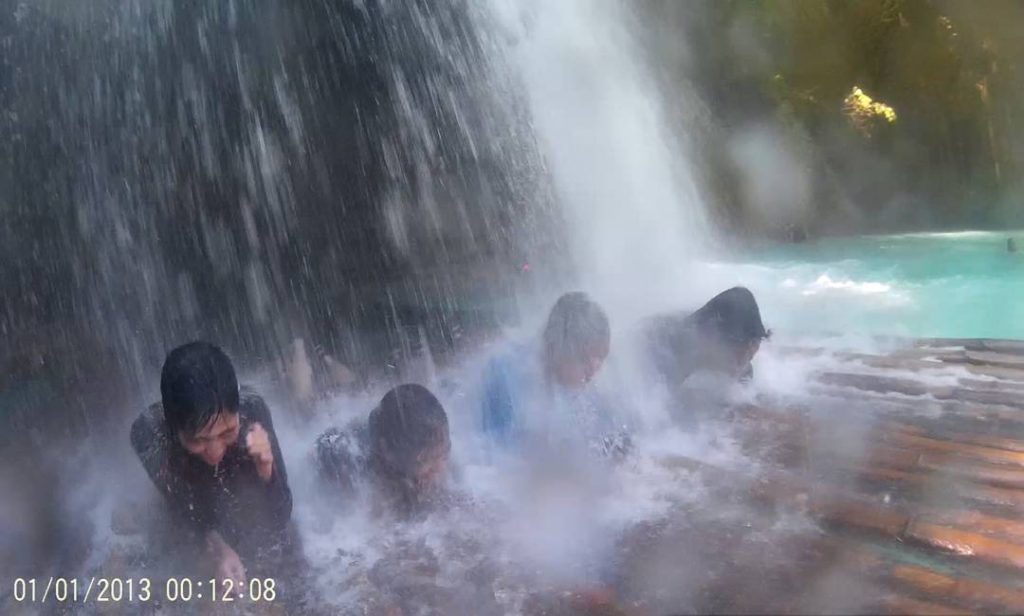 having a water massage under the kawasan falls