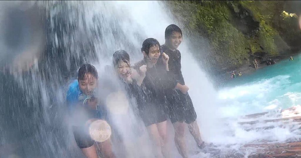 having a water massage under the kawasan falls