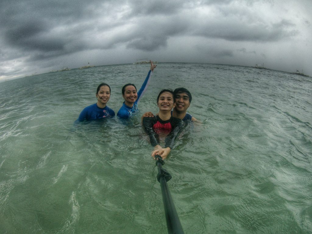 enjoying the beach with friends at a panglao bohol beach resort