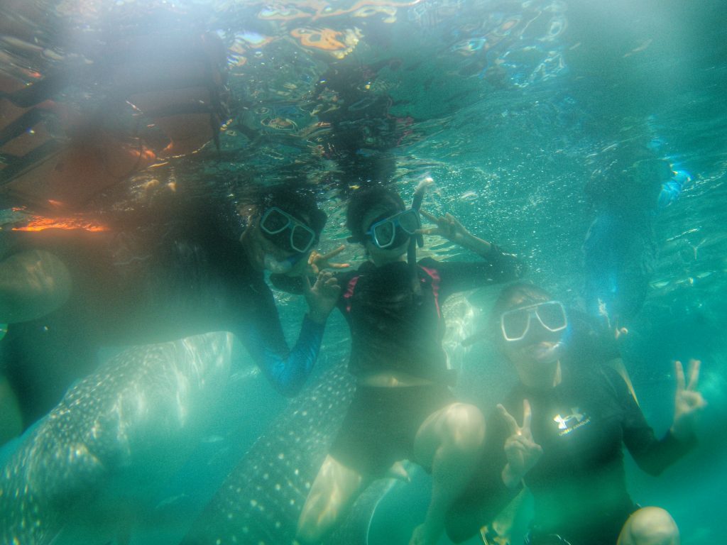 me and my friends are trying to swim beside our boat
