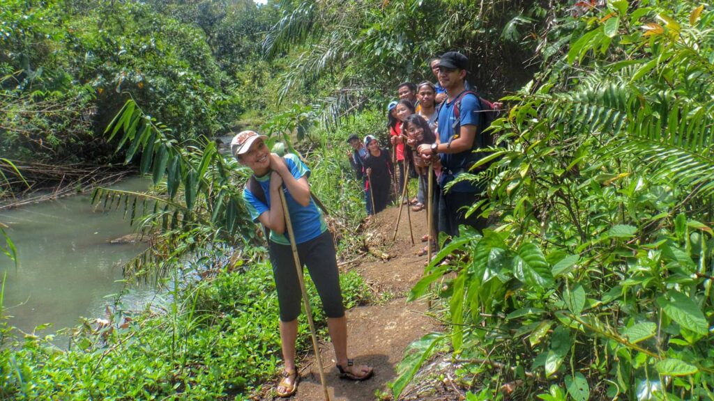 Trekking to Aliw Falls on a muddy trail