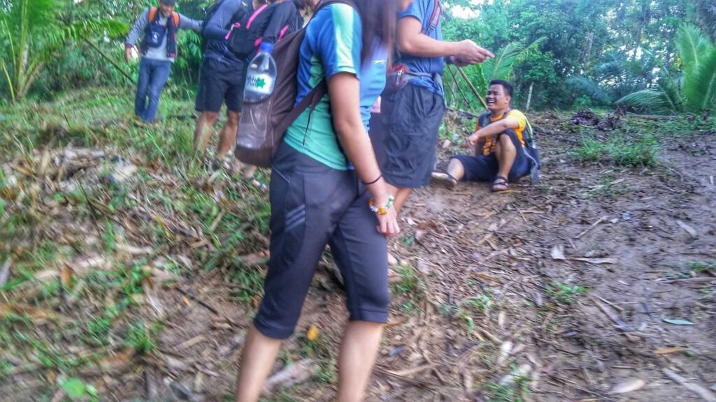 A man slid to his butt because of the muddy trail going to Hulugan Falls