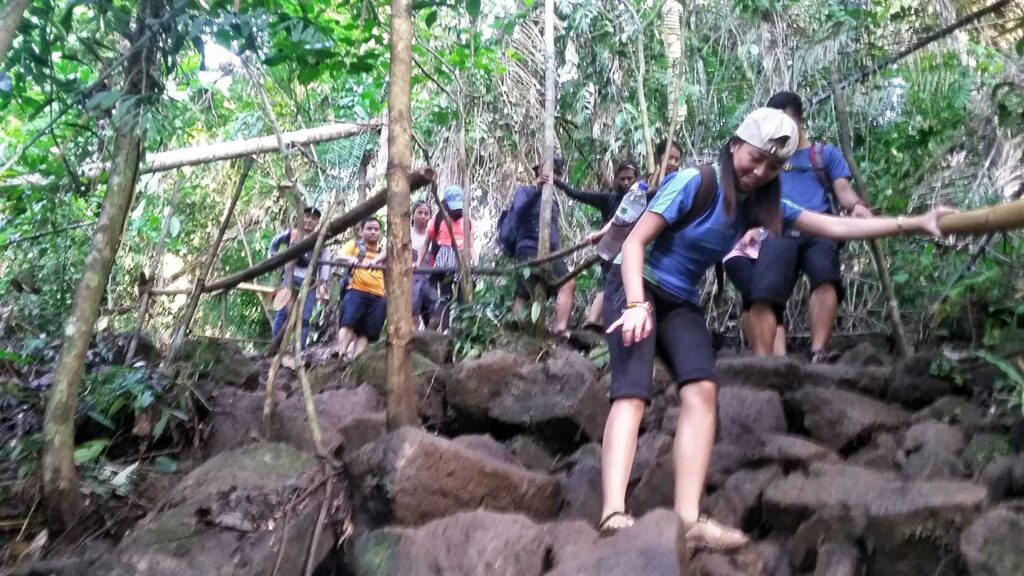 trekking down a rocky trail going to Hulugan Falls