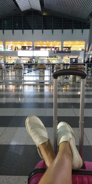resting my feet on top of my luggage while waiting for our flight to cebu in the airport